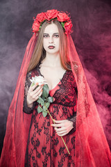 witch vampire girl in red dress with red veil - 303910748