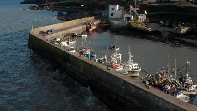 Aerial Shot of South Ireland Quay during a sunny day. Boats are anchored at the jetty.