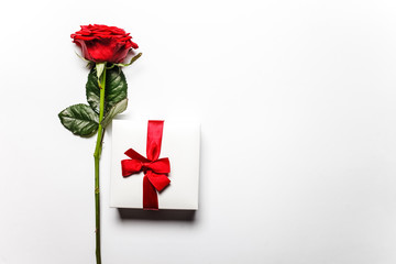 Concept of romantic gift in the form of the red rose and boxes with jewelry