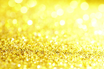gold Sparkling Lights Festive background with texture. Abstract Christmas twinkled bright bokeh defocused and Falling stars. Winter Card or invitation	