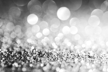 Silver Sparkling Lights Festive background with texture. Abstract Christmas twinkled bright bokeh defocused and Falling stars. Winter Card or invitation	