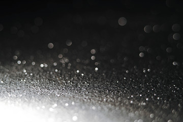 Silver Sparkling Lights Festive background with texture. Abstract Christmas twinkled bright bokeh defocused and Falling stars. Winter Card or invitation	