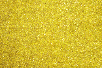 gold Sparkling Lights Festive background with texture. Abstract Christmas twinkled bright bokeh defocused and Falling stars. Winter Card or invitation	