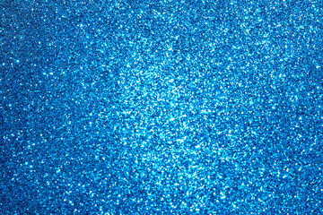 blue Sparkling Lights Festive background with texture. Abstract Christmas twinkled bright bokeh defocused and Falling stars. Winter Card or invitation	