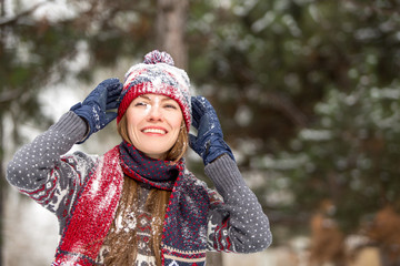 Fototapeta na wymiar Happy beautiful woman having fun with snow outdoors in winter scenery
