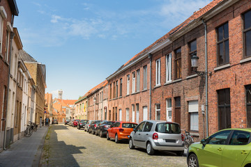 Fototapeta na wymiar Row of cars on cozy street in old town, Europe