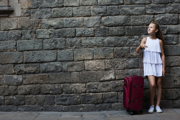 girl in white with travelling bag