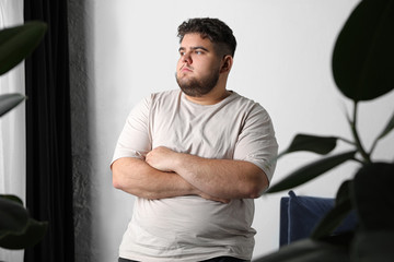 Overweight man suffering from depression at home