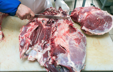 cutting meat in the meat shop