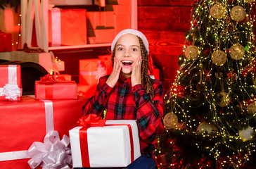 Obraz na płótnie Canvas Christmas shopping. new year is coming. Kid enjoy the holiday. child girl with xmas present. hello from santa. surprise. small happy girl at christmas tree. morning before Xmas. family holiday time