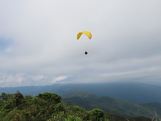 paraglider flight in cloudy day