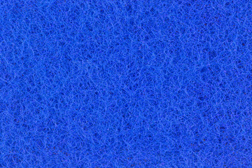 Fototapeta na wymiar Abstract texture of the blue surface washcloths for washing dishes macro close-up background