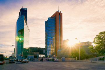Sunset at road and street with Glass Business office building architecture in Modern City in Vienna, Austria. Urban corporate skyscraper exterior and skyline. Blue windows design of Finance commercial