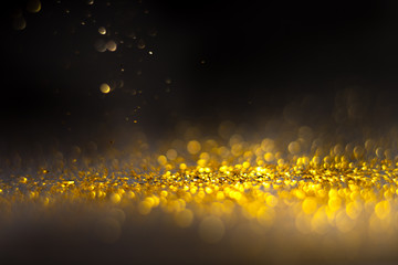 Glitter gold grunge blur abstract background. Lights twinkly dust and christmas texture