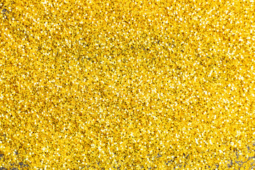 Glitter gold grunge blur abstract background. Lights twinkly dust and christmas texture