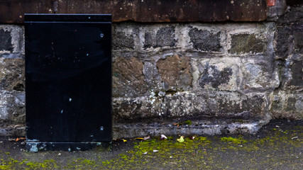 Black service box against wall