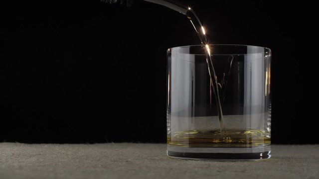 whiskey is poured into a glass