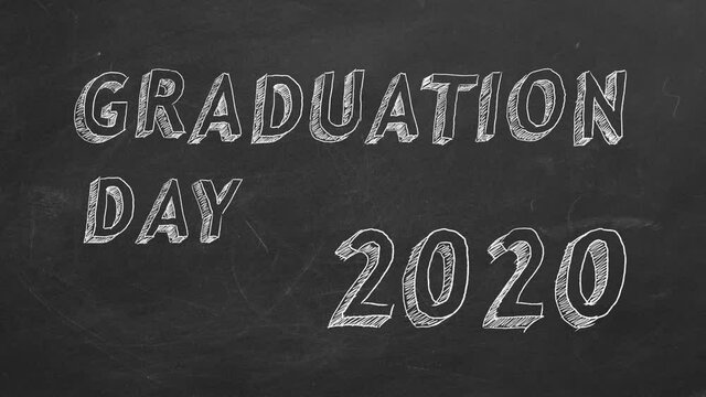 Hand drawing and animated text "Graduation day. 2020." on blackboard. Stop motion animation.