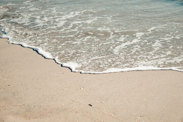 On the picture is Pacific Ocean Long Beach shore. Azure blue sea water disappears in the sand.