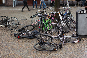 Fototapeta na wymiar After the storm in Amsterdam, rainy windy day. Bikes, scooters and trees fallen 