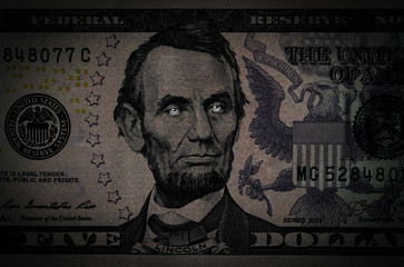 Portrait of Abraham Lincoln on a 5 US dollars banknote.