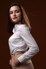 Portrait of a beautiful girl in a white blouse
