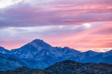 Fototapeta na wymiar Aspen, Colorado rocky mountains colorful purple pink blue sunset twilight with Snowmass mountain peak ridge closeup