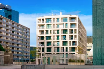 Zelfklevend Fotobehang Modern residential apartment with flat building exterior in Vienna of Austria. New luxury house and home complex. City Real estate property and condo architecture. Facade of condominium block. © Roman Babakin