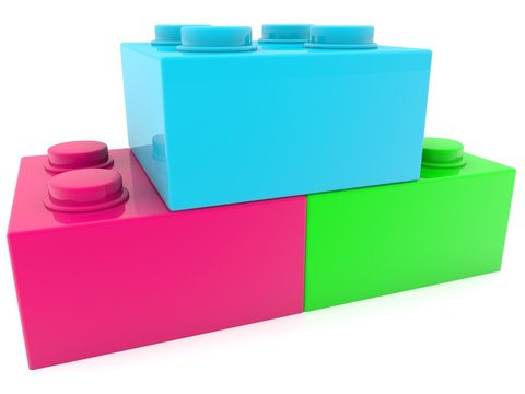 Three different colored toy bricks in close-up
