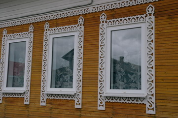 carved shutters on the Windows of a wooden house