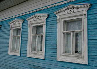 carved shutters on the Windows of a wooden house