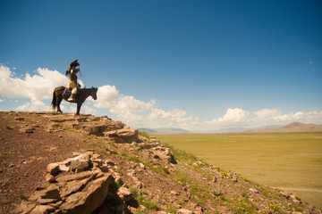 Kazakh eagle hunter on his horse in altai mountains, mongolia