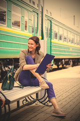 beautiful middle-aged woman traveler on a railway station