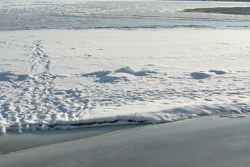 trail on the frozen river, footprints on the ice