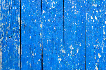 background wooden old fence made of boards, blue, shabby paint, aged texture