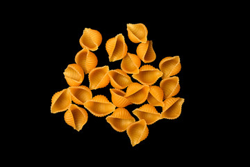 pasta unprepared raw conchiglie rigate shells of durum wheat handmade isolated on black background