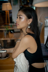 Asian smile girl in a cafe. Beautiful Balinese women with a cup of coffee
