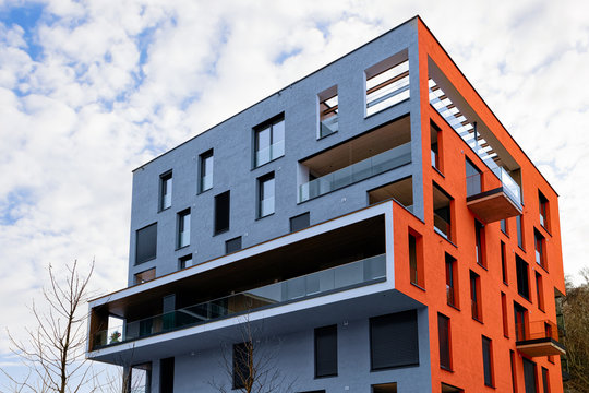 Colorful Modern Residential Apartment And Flat Building Exterior In Salzburg, In Austria. New Luxury House And Home Complex Of Blue And Red Color. City Real Estate Property And Condo Architecture.