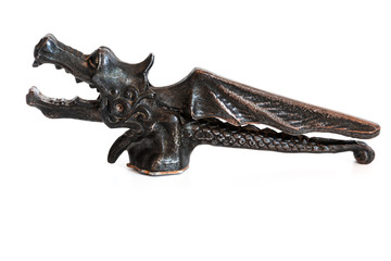Old vintage nutcracker isolated on white background, walnut cracker as a dragon with wings made of...