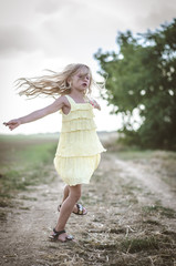 beautiful child running in the nature in rural countryside