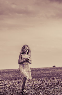 strange image of girl alone in the field