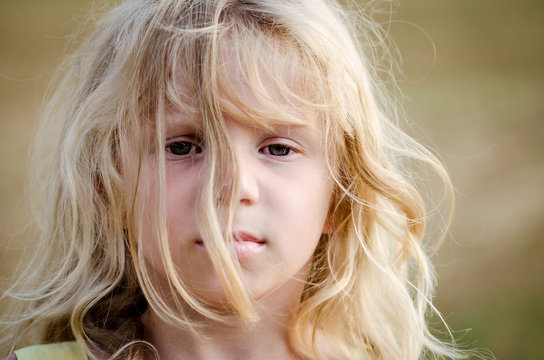 beautiful wild child with messy long blond hair portrait