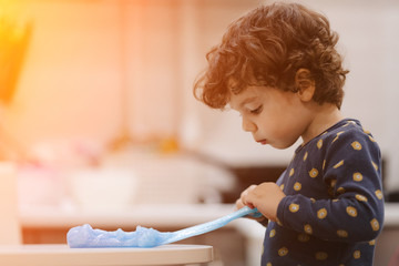 little kinky boy playing with slime in his room