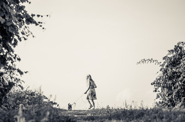 Obraz na płótnie Canvas little child walking with cat in lead