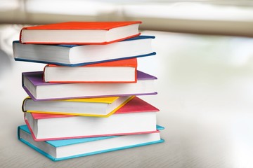 Colorful books collection on background.