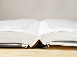 open book with pages on a wooden table close-up macro