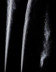 trail from a jet engine on a black background, spraying particles under high pressure