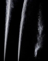 trail from a jet engine on a black background, spraying particles under high pressure