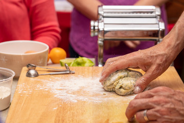 Obraz na płótnie Canvas Process of making pasta with herbed pasta dough