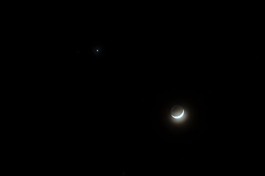 Crescent moon and star during the night time